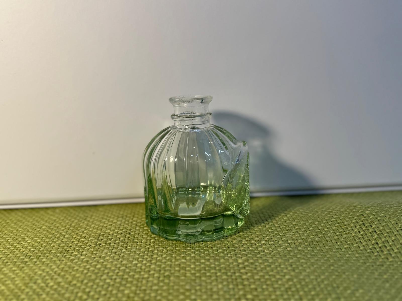 The Short, Embossed Round Bottle
